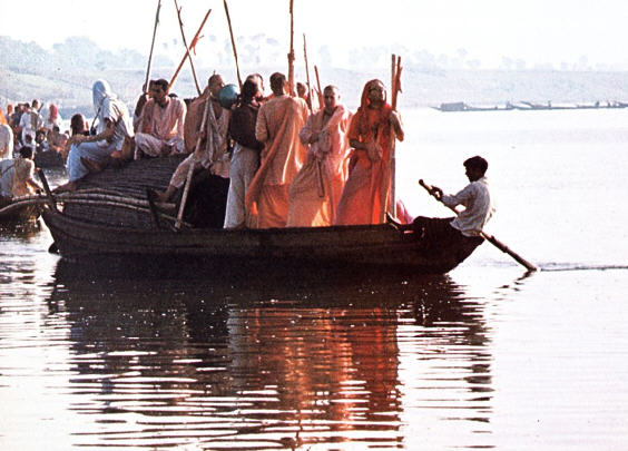 Devotees Cross The Ganga River