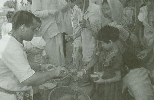 Pilgrims Receive Cups of Kicchari Prasadam