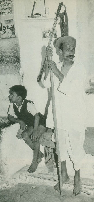 A Temple Gatekeeper Stand Guard with His Son